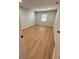 An inviting bedroom features natural light, neutral walls, and wood-look laminate flooring at 2602 Surrey Dr, Palm Harbor, FL 34684