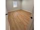A bright bedroom featuring hardwood flooring and a window with bright light at 2602 Surrey Dr, Palm Harbor, FL 34684