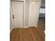 This entryway features a white front door, a white closet door, and wood-look floors at 2602 Surrey Dr, Palm Harbor, FL 34684