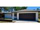 Charming single-story home featuring a dark garage door, a well-manicured lawn and a clearly visible house number at 2602 Surrey Dr, Palm Harbor, FL 34684