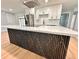 Modern kitchen featuring a sleek island with unique gold vein decor, stainless steel appliances, and ample cabinet space at 2602 Surrey Dr, Palm Harbor, FL 34684