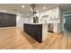 Modern kitchen with white cabinets, stainless steel appliances, and a stylish island at 2602 Surrey Dr, Palm Harbor, FL 34684