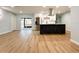Bright open living space features wood floors and connects to a kitchen with stainless steel appliances at 2602 Surrey Dr, Palm Harbor, FL 34684