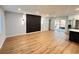 Bright open living space features wood floors, modern wall decor, and connects to a kitchen with stainless steel appliances at 2602 Surrey Dr, Palm Harbor, FL 34684