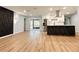 Bright open living space features wood floors, modern wall decor, and connects to a kitchen with stainless steel appliances at 2602 Surrey Dr, Palm Harbor, FL 34684