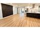 Bright open living space features wood floors, modern wall decor, and connects to a kitchen with stainless steel appliances at 2602 Surrey Dr, Palm Harbor, FL 34684