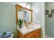 Bathroom featuring a wood vanity, decorative plant, and an updated mirror at 2833 56Th N Ln, St Petersburg, FL 33710