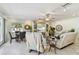 Cozy living room with tile flooring, comfortable seating, a ceiling fan, and a decorative entertainment center at 2833 56Th N Ln, St Petersburg, FL 33710