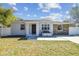 Charming home featuring a stone accent wall, updated paint, and a well-maintained front yard at 3010 W Van Buren Dr, Tampa, FL 33611