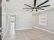 Spacious living room with neutral tile flooring, a modern ceiling fan, and recessed lighting at 3010 W Van Buren Dr, Tampa, FL 33611