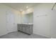 Bathroom featuring a double sink vanity with granite counters, and a tiled walk-in shower at 30910 Penny Surf Loop, Wesley Chapel, FL 33545