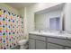 Bathroom featuring a shower with a colorful curtain and dual vanity with a granite counter at 30910 Penny Surf Loop, Wesley Chapel, FL 33545