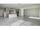 Open-concept living area with tiled floors and abundant natural light, flowing into the kitchen at 30910 Penny Surf Loop, Wesley Chapel, FL 33545