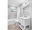 Bright bathroom featuring a tub with marble surround and vanity with a carrara marble countertop at 3104 Bay St, Sarasota, FL 34237