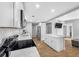 Well-lit kitchen featuring white cabinets, a center island, stainless steel appliances, and open layout at 3104 Bay St, Sarasota, FL 34237