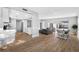Open-concept living and dining area with hardwood floors, neutral décor and views of the pool at 3104 Bay St, Sarasota, FL 34237