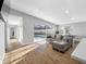 Bright living room with views of the pool, hardwood flooring, and a comfortable gray sofa at 3104 Bay St, Sarasota, FL 34237