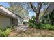 View of the property's backyard with mature trees, landscaping, and patio area perfect for outdoor living and entertaining at 3416 Annette Ct # 71, Clearwater, FL 33761