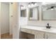 Bathroom featuring a built-in vanity with two sinks, two mirrors, a large counter and ample storage at 3416 Annette Ct # 71, Clearwater, FL 33761