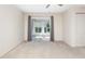 Open bedroom space featuring neutral carpet and natural light from the sliding glass doors to the screened porch at 3416 Annette Ct # 71, Clearwater, FL 33761
