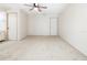Spacious bedroom with plush carpet, a ceiling fan, and doors to the bathroom and hallway at 3416 Annette Ct # 71, Clearwater, FL 33761