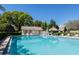 Beautiful community pool with chairs and shade, perfect for relaxing and enjoying outdoor leisure time near the pool house at 3416 Annette Ct # 71, Clearwater, FL 33761