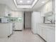 Functional kitchen with a skylight, white cabinets, and modern appliances at 3416 Annette Ct # 71, Clearwater, FL 33761