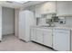 Bright kitchen featuring white cabinets, tiled flooring, and efficient layout at 3416 Annette Ct # 71, Clearwater, FL 33761