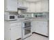 Modern kitchen with white cabinets, updated stainless steel oven, and ample counter space at 3416 Annette Ct # 71, Clearwater, FL 33761