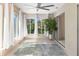 Relaxing sunroom filled with natural light, tiled floors, ceiling fan and view of the garden at 3416 Annette Ct # 71, Clearwater, FL 33761