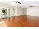 Bright and airy living room with elegant wood floors, ceiling fans, and a view of the lanai at 3416 Annette Ct # 71, Clearwater, FL 33761