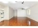 Open-concept living room featuring wood floors, ceiling fan, and seamless access to the kitchen at 3416 Annette Ct # 71, Clearwater, FL 33761