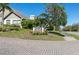 A stately sign for Chateau Woods sits amidst a lush green lawn, creating a welcoming entrance to this charming neighborhood at 3416 Annette Ct # 71, Clearwater, FL 33761