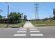 A clear street view highlighting a pedestrian crosswalk in a well-maintained neighborhood, with power lines overhead at 3416 Annette Ct # 71, Clearwater, FL 33761