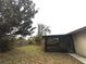 Backyard with screened in patio and wooden fence at 3608 Oak Bark Ln, Brandon, FL 33511