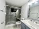 Bathroom featuring walk-in glass shower with marble design, white toilet, and custom vanity at 3608 Oak Bark Ln, Brandon, FL 33511