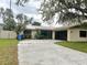 Single story home with metal roof, black framed windows, stone accent and updated driveway at 3608 Oak Bark Ln, Brandon, FL 33511