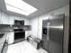 Kitchen features stainless steel appliances and ample cabinet space at 3608 Oak Bark Ln, Brandon, FL 33511
