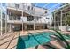 Beautiful backyard with a screened-in pool, lush greenery, an outdoor grill, and patio furniture at 375 Wellington Ave, Oldsmar, FL 34677