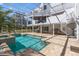 A spacious backyard with a screened-in pool, hot tub, spiral staircase, and outdoor grill at 375 Wellington Ave, Oldsmar, FL 34677
