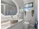 Modern bathroom with a sleek vanity, stylish sink, lighted mirror and minimalist design at 375 Wellington Ave, Oldsmar, FL 34677
