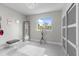 Well-lit bedroom features a plush rug, floor mirror and modern minimalist décor at 375 Wellington Ave, Oldsmar, FL 34677