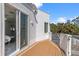 Outdoor deck perfect for relaxing with white siding, outdoor trees and beautiful blue skies above at 375 Wellington Ave, Oldsmar, FL 34677