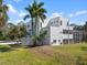 A home with well-manicured lawn with Palm trees and a light colored exterior paint at 375 Wellington Ave, Oldsmar, FL 34677