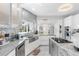 Stylish kitchen featuring marble countertops, stainless steel sink, and contemporary lighting at 375 Wellington Ave, Oldsmar, FL 34677