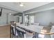 Open-concept living area with hardwood floors, modern lighting, and stylish furniture at 375 Wellington Ave, Oldsmar, FL 34677