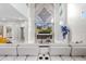 Bright living room with modern fireplace and large TV, framed by a dramatic marble accent wall at 375 Wellington Ave, Oldsmar, FL 34677