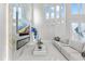 Living room features tall windows, a modern fireplace framed with marble, and a sleek white sofa at 375 Wellington Ave, Oldsmar, FL 34677