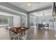 Bright, open living room with hardwood floors, ceiling fans, and a view of the outdoor pool area at 375 Wellington Ave, Oldsmar, FL 34677