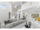 Bright and spacious living room boasting high ceilings, a modern staircase, and sleek marble floors at 375 Wellington Ave, Oldsmar, FL 34677